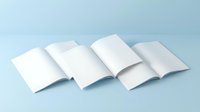 Open blank white booklets and brochures arranged on light blue background for mockup design templates and printing projects.