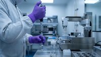 Laboratory scientist in purple gloves using pipette for precise liquid sample analysis in modern sterile research facility for pharmaceutical development.