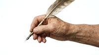 Elderly hand holding vintage feather quill pen for writing calligraphy or signing documents on white background isolated for design projects.