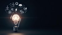 Glowing light bulb with renewable energy icons floating above on dark background representing sustainable innovation and green technology solutions.