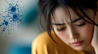 Young Asian woman in yellow sweater with closed eyes expressing serenity and peace against blurred background with artistic blue paint splatter effect.