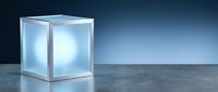 Glowing cube with illuminated interior on concrete surface against blue gradient background, suitable for technology, innovation, and modern design concepts.