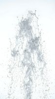 Dynamic water splash frozen in motion with droplets and streams cascading upward against white background, isolated for design use on merchandise and promotional materials.