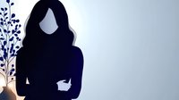 Minimalist silhouette of young woman with crossed arms against light background, decorative plant branch with blue leaves creates artistic composition.