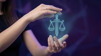 Hands protecting glowing justice scales symbol representing legal protection, law firm services, and balanced judgment in professional legal consultation.
