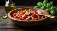Fresh bruschetta topping with diced tomatoes, basil and garlic in wooden bowl. Italian appetizer ingredients ready for cooking and serving.