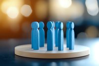 Blue wooden figures standing in circle on white platform against blurred bokeh background representing team unity, leadership, collaboration and community concept.