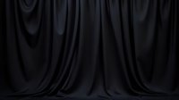 Dark black fabric backdrop with elegant flowing folds and dramatic shadows creates moody atmosphere for professional studio photography and product displays.