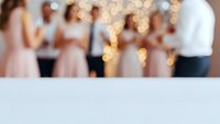 Blurred wedding reception with warm bokeh lights and guests celebrating in background, copy space for text overlay and romantic event design projects.