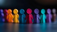 Colorful wooden figures standing in row on dark background with dramatic lighting, symbolizing diversity, unity and teamwork in business or community.