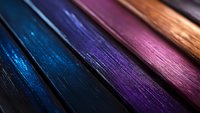 Diagonal lines of metallic texture in blue, purple, and pink colors create abstract background with dramatic lighting and selective focus for modern design.