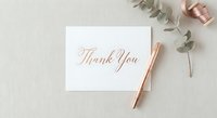 Elegant thank you card with rose gold calligraphy on white paper, styled with eucalyptus leaves and copper pen for wedding stationery mockup.