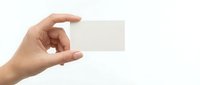 Hand holding blank white business card mockup on clean background for branding and corporate identity design projects.