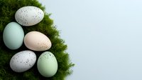 Pastel colored speckled eggs arranged on fresh green moss against light background, creating natural spring composition for seasonal and holiday designs.
