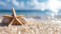 Starfish and seashells on sandy tropical beach with sparkling ocean waves and soft bokeh light effect in background, summer vacation concept.