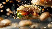 Fresh sesame burger with vegetables and meat patty in dynamic composition with flying ingredients and bokeh effect on dark background.
