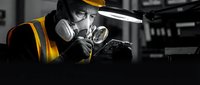 Professional welder in protective gear working with bright welding torch in industrial workshop. Skilled craftsman focused on precision metalwork and fabrication.