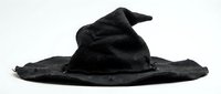 Old weathered black wizard hat with torn brim isolated on white background for Halloween costume design and magical themed projects.