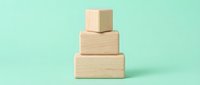Stacked wooden blocks on mint background, isolated for design, packaging, business concepts, and creative projects.