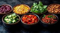 Fresh ingredients in wooden bowls arranged in row showing variety of colorful healthy food components including beans, corn, tomatoes, cucumbers and herbs on dark background.