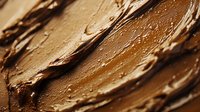 Rich chocolate spread with smooth creamy texture showing delicious swirls and peaks, food photography for culinary and dessert applications.