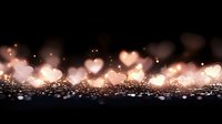 Romantic glowing heart bokeh lights on dark background with sparkles and glitter. Soft focus Valentine's day abstract background for greeting cards and banners.