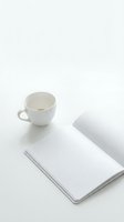 White ceramic cup with tea or coffee next to open lined notebook on clean surface, isolated for design use on websites, blogs, stationery mockups.