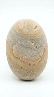 Smooth weathered stone egg isolated on white background for natural decor and zen meditation concepts.