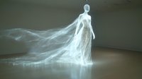 Ethereal glowing female figure with flowing translucent dress floating in dark space, creating mystical light trails and reflections on floor. Supernatural artistic concept.