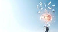 Light bulb with glowing brain inside surrounded by business icons on blue gradient background representing innovation and creative thinking concepts.
