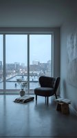 Modern high-rise apartment interior with black armchair, potted plant, and panoramic city skyline view through floor-to-ceiling windows, minimalist home decor.