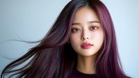 Young Asian woman with flowing purple ombre hair against light background, natural makeup and serene expression showcasing modern hair coloring and beauty trends.