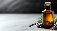 Amber glass essential oil bottle with fresh lavender flowers on light marble surface against dark background. Wellness and aromatherapy concept.