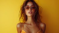 Young Asian woman in sunglasses and yellow top against vibrant yellow background, messy hair style creates summer mood, fashion portrait with warm lighting and minimal composition.