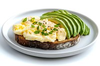 Scrambled eggs on dark toasted bread garnished with fresh sliced avocado, herbs and red pepper flakes served on gray ceramic plate against white background.