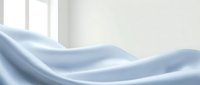 Soft blue silk fabric with elegant flowing waves and gentle folds creating luxurious textile background for fashion and interior design projects.