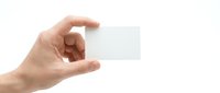 Hand holding blank white business card mockup on isolated background for corporate branding and contact information design templates.