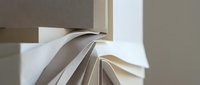 Stack of open books with pages fanned out, showcasing reading materials and literature for education, learning, and knowledge concepts.