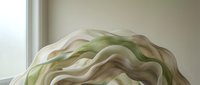 Flowing organic fabric with soft waves in cream, sage green, and taupe tones creates an abstract, ethereal composition suitable for textile design and contemporary decor projects.
