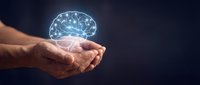Adult male hands holding glowing brain hologram against dark background, representing artificial intelligence, innovation, and digital technology concepts for business and healthcare.