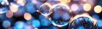 Transparent glass spheres reflecting magical bokeh lights against blurred blue and orange background, creating dreamy festive atmosphere. Macro photography.