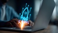 Glowing blue rocket hologram emerging from laptop keyboard in dark office setting, symbolizing business startup launch and digital transformation concept.