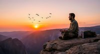 Young bearded man meditating on mountain cliff at sunrise with flying birds overhead. Peaceful outdoor yoga and mindfulness concept for wellness lifestyle.