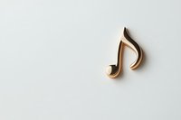 Golden musical note symbol on light background with soft shadow, minimalist composition for music and entertainment concepts.
