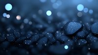 Dark stones with water drops and bokeh lights creating magical atmosphere on black background, macro photography with shallow depth of field.