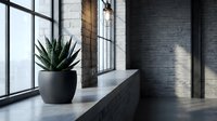 Modern minimalist interior with potted succulent plant on concrete windowsill, industrial loft space with large windows and brick walls, contemporary home decor and design.