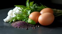 Fresh brown eggs with aromatic herbs, garlic cloves and pink salt crystals on dark background, dramatic food photography composition for cooking blogs.
