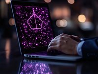 Glowing purple pentagon shape on laptop screen with sparkle effects and bokeh background, hands typing on keyboard in dark office environment.