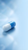 Blue and white pharmaceutical capsule pill on soft blue background for medical healthcare and medication concepts.