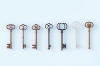 Collection of vintage skeleton keys arranged in row on light blue background, featuring ornate designs and different metallic finishes, isolated for design use.